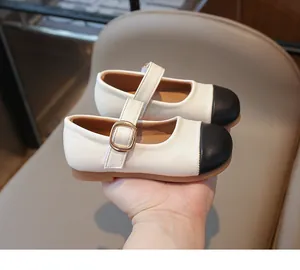 Close-up of color-block Mary Jane shoes for girls featuring a golden metallic buckle
