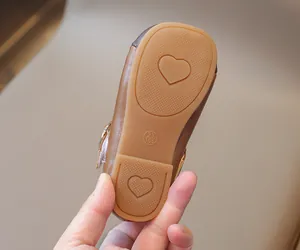 Detail of baby Mary Jane shoe rubber sole with anti-slip heart patterns and size marking