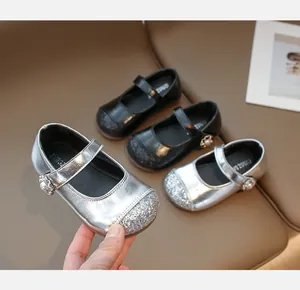 Detailed macro of shiny glitter finish and pearl flower buckle on girls' Mary Jane shoes