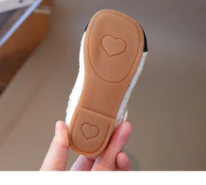 Close-up of non-slip brown rubber sole with heart patterns for girls princess shoes