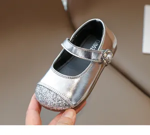 Detailed close-up of girls' silver sequin Mary Jane shoes with pearl floral buckle
