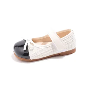 Elegant girls' white tweed Mary Jane shoes with black patent leather toe and bow accent