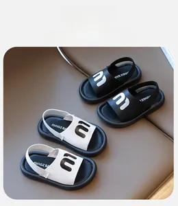 Detailed top view of kids fashion sandals with letter M decoration and elastic heel straps