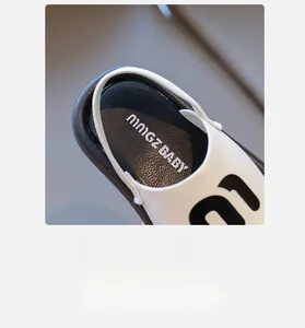 Detail of soft breathable inner lining and NINGZ BABY insole on kids' black and white sandals
