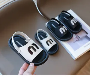 Detailed close-up of summer toddler sandals with m-letter logo and elastic heel strap