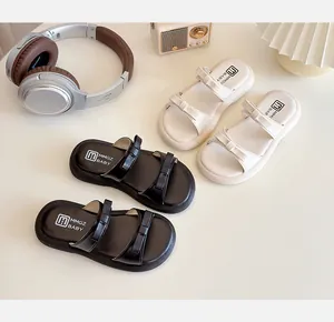 Close-up of children's thick-soled leather sandals with double bowknot design