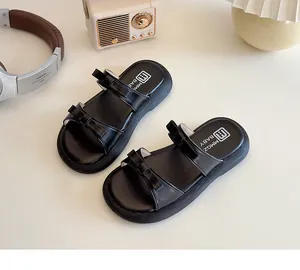 Detailed view of black bow-knot sandals with double straps and anti-slip thick soles