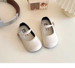 Detail of cream Mary Jane shoe featuring floral pearl buckle and decorative stitching