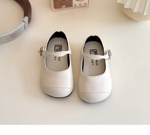 Detail shot of cream white girls Mary Jane shoes with soft sole and stitch texture