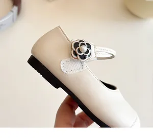 Detailed close-up of a cream Mary Jane flat shoe for girls with camellia pearl detail