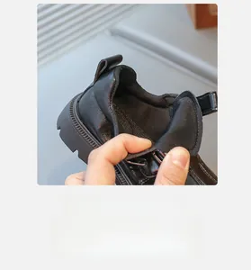 Detail view of the breathable lining and padded interior of the black leather kids shoes