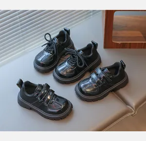 Classic black kids loafers featuring lace-up and velcro straps with polished finish