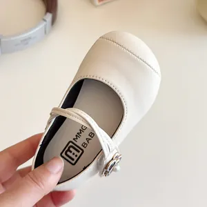 Chic beige Mary Jane leather shoes for girls featuring floral pearl buckles and soft soles