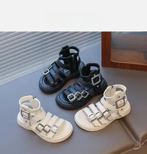 Detail showing Roman sandals for girls in black and beige with silver metal buckles