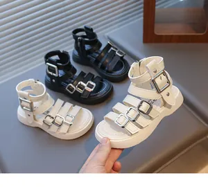 Detailed view of kids Roman sandals featuring multi-layer straps and metal buckles