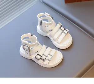 Detailed view of white girls' gladiator sandals with silver buckles and back zipper