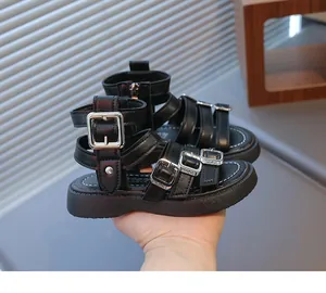 Detailed view of kids black roman sandals with silver buckles and back zipper closure