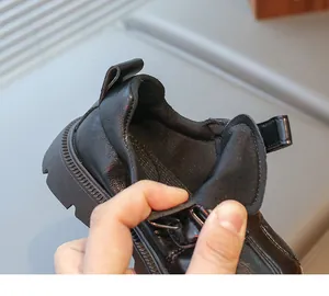 Detail of children's black patent leather shoes showing soft lining and non-slip rubber sole