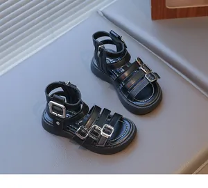 Detailed view of girls black gladiator sandals with silver buckles and back zipper