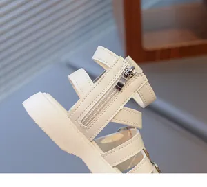 Detail view of cream girl's roman sandals with side zipper and thick soft soles