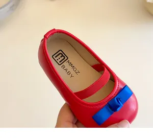 Nahaufnahme roter Mary Jane Prinzessinnenschuh mit dunkelblauer Schleife und weicher Sohle