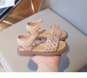 Détail de sandales de princesse pour enfants avec fleurs en cuir et bride velcro