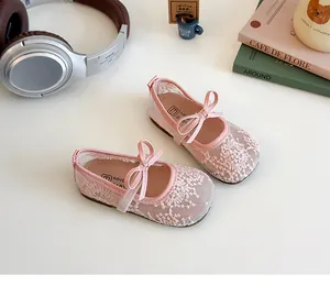 Gros plan sur des babies en dentelle rose avec broderie florale et nœud en satin