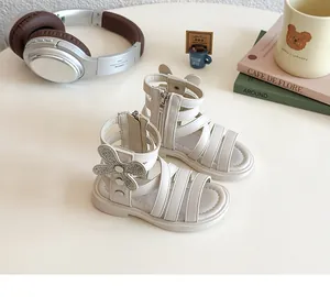 Detailed view of kids roman sandals with rhinestone bows and back zipper in cream white