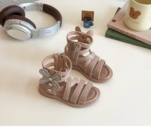 Detail of pink girls' Roman sandals featuring rhinestone bows and easy back zipper