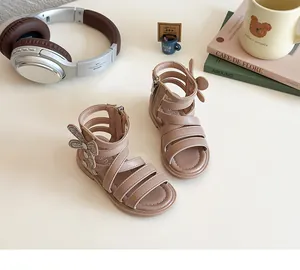 Detail of pink girls' Roman sandals with rhinestone bow and convenient side zipper