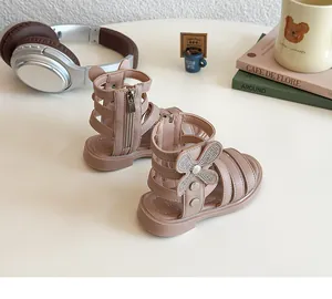 Detail of pink toddler gladiator sandals with rhinestone bows and cute ear heel detail