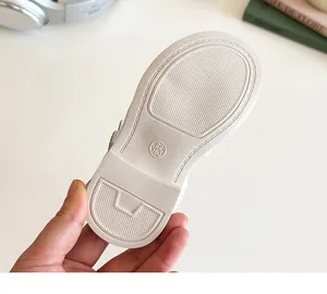 Detail of white rubber anti-slip sole with size 22/160 marking on girls sandals
