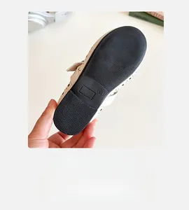Detail view of non-slip rubber sole with size 26 marking on girls princess flat shoes
