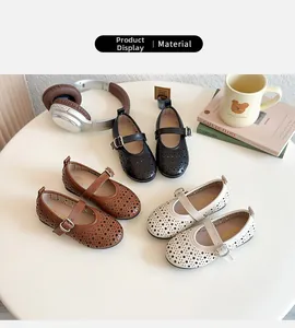 Top view of hollow floral Mary Jane shoes in black, brown, and cream for girls