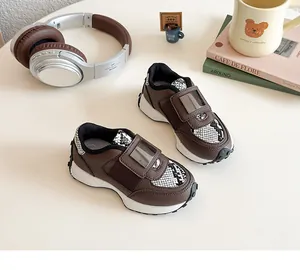 Détail de basket décontractée pour enfants en cuir marron avec motifs imprimés serpent chic