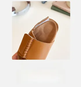 Detail view of brown toddler sandals featuring a secure velcro closure and soft inner lining
