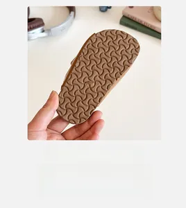 Detailed view of the anti-slip wavy texture and size mark on the girl's sandal sole