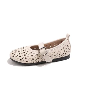 Girl's beige hollowed-out Mary Jane flats with rubber soles and strap buckles