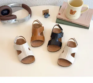Three pairs of girls open-toe sandals in white, brown, and black with velcro straps