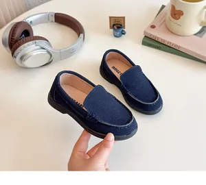 Dettaglio di mocassini scamosciati blu scuro per bambini con cuciture a U e suola morbida
