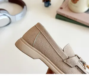 Detail of apricot suede kids loafer showing premium stitching and soft matte texture