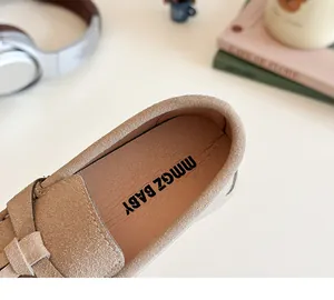 Detail of children's khaki suede loafers with woven accents and soft inner lining