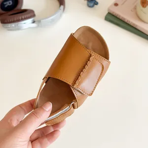 Girl's brown leather open-toe sandals with woven stitching and soft ergonomic sole