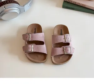 Detailed top view of pink kids dopamine slides with double silver metal buckles on white background