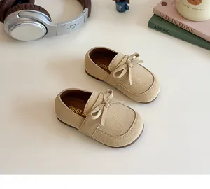 Detail of beige bow princess shoes for girls in a lifestyle aesthetic setting