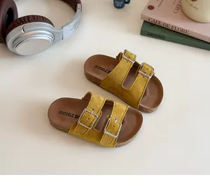 Close-up of vibrant yellow suede kids double buckle slide sandals with cork sole