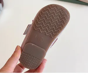 Detail of pink suede girl shoes showing anti-slip rubber sole with wavy texture and size 23