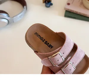 Close-up of pink girls' cork sandals with adjustable double metal buckles and soft footbed