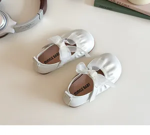 Detail shot of white Mary Jane shoes with organza bow and soft inner sole for toddlers