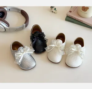 Detail of children's princess flats in silver, black and beige with lace bows